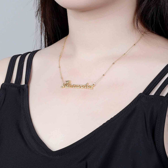 queen name necklace gold worn by a women